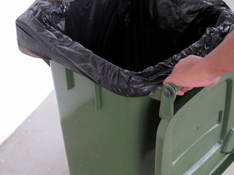 Staff performing maintenance checks on a waste collection vehicle
